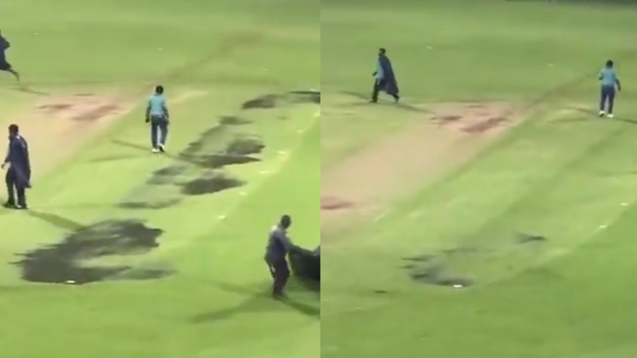 Ground staff workers cover patches of wet ground with black tarpaulin sheets on a cricket field, likely to protect the pitch and outfield from rain. The image is split into two sections showing similar actions. | jeetwinbet.com